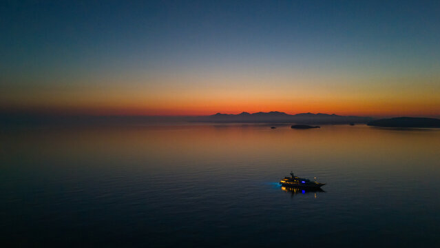 Quiet early pre dawn sunrise with colorful sky over Aegean Sea at Mandrakia village on Greek island Milos in Greece.
