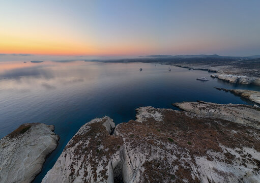 Quiet early pre dawn sunrise with colorful sky over Aegean Sea at Mandrakia village on Greek island Milos in Greece.