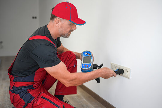A electrician using multifunction tester for revision of electrical circuits . Initial verification and periodic inspection and testing of electrical installations.