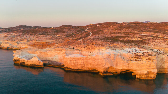 Quiet early pre dawn sunrise with colorful sky over Aegean Sea at Mandrakia village on Greek island Milos in Greece.