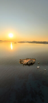 Quiet early pre dawn sunrise with colorful sky over Aegean Sea at Mandrakia village on Greek island Milos in Greece.