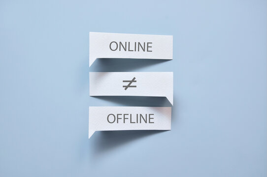 Online and offline paper labels with an uneven sign, emphasizing the difference between the digital and physical experience.