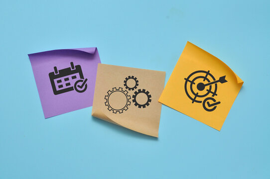 Conceptual composition of calendar, gears and target symbols representing planning, process management, strategy and goal achievement.