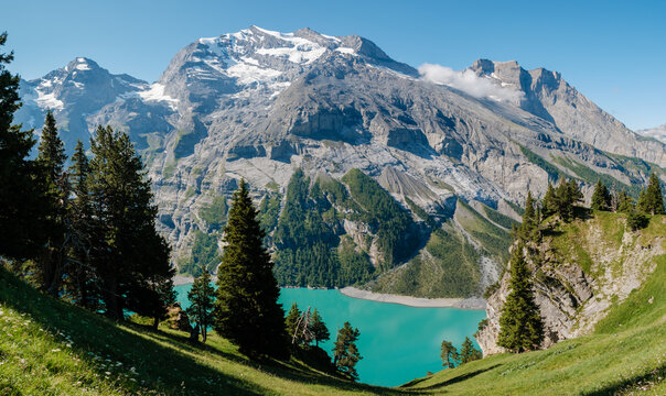 Majestic views of Oeschinensee in Kandersteg, Switzerland glowing in summer sunshine