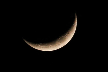 Crescent moon glows softly against velvet night sky © Dian