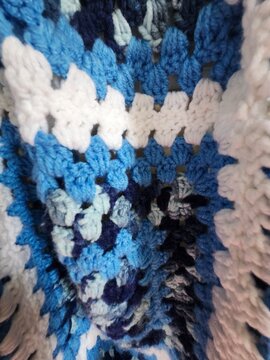 blue fabric texture white folded afghan handmade blanket granny square cozy winter christmas