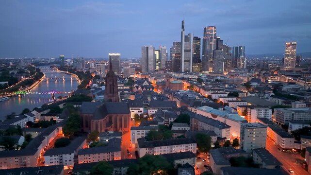 Erial Urban skyline at dusk with buildings and river in city of Frankfurt, Germany