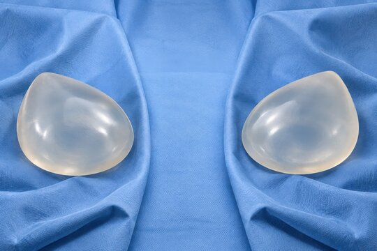 Pair of silicone breast implants on sterile blue drape