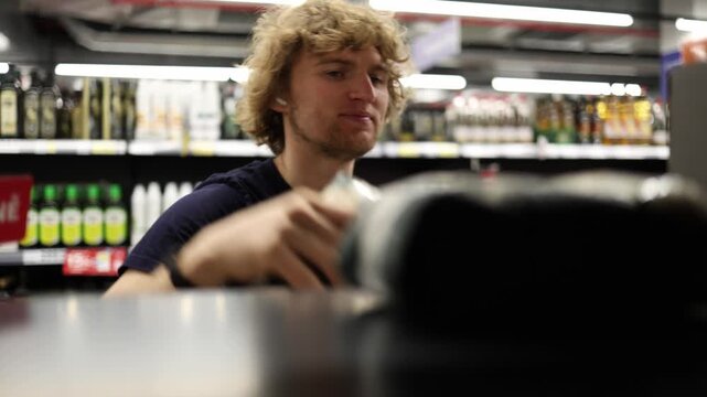 Shopper finally decides to take his favorite treat from the supermarket shelf after hesitation showing temptation satisfaction reward and a small moment of indulgence now