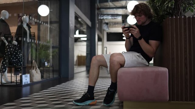 Student plays mobile games on his smartphone instead of studying and developing skills showing digital distraction procrastination screen addiction and wasted free time daily