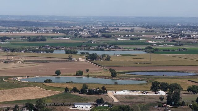 Aerial of rural reservoir and agricultural fields in Larimer County Colorado with cultivated fields