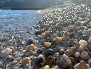 close up of some colorfoul pebbles being hit by the waves at a beach in Baska, Croatia © Isabella