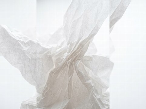 Crumpled white tissue paper texture with soft shadows and copy space