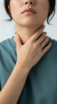 Close-up of a person's throat with hand touching, symbolizing self-care, health, or a moment of reflection.