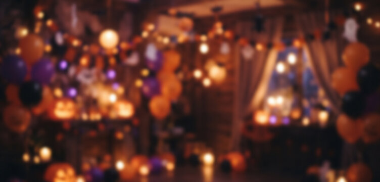 Festive Halloween party room with fully blurred pumpkins, decorations, glowing lights, and orange purple bokeh creating an energetic seasonal celebration background.