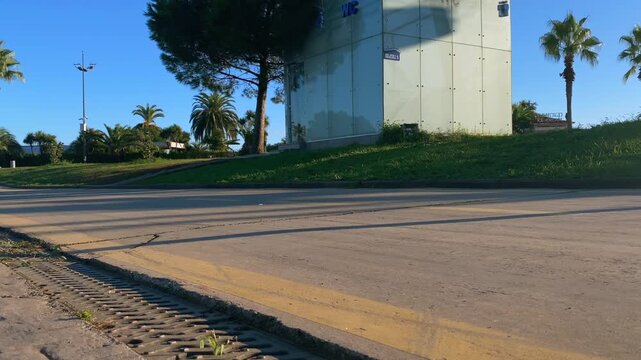 Inline skater gliding low angle along a paved urban path, showing outdoor exercise and balance training for recreation, fitness, active mobility, sports practice and everyday transportation