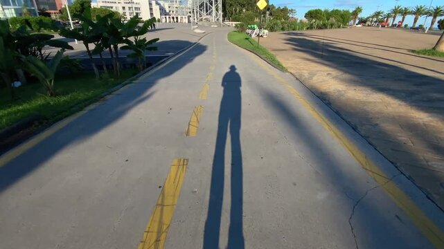 Inline skater rolling POV shot along a seaside cycle lane, showing personal mobility and outdoor commuting for active transport, urban recreation, fitness travel and waterfront infrastructure use