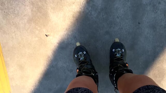 Inline skater gliding, top-down view over pavement with long shadow, showing personal mobility, active commuting, outdoor fitness and micromobility use in urban transport and recreation media
