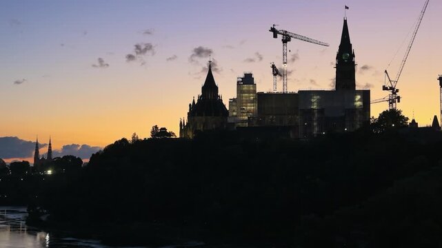 Ottawa, Ontario, Canada - September 12, 2026: Sunset Timelapse Silhouette of Parliament Hill Architecture and Construction Cranes