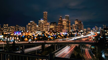 Obraz premium Illuminated Modern City Skyline with Highway Traffic Light Trails at Night