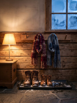 Cozy winter cabin interior with snow boots and scarves serving as a copertina libro amore romantic backdrop