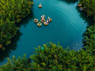 Obraz premium Aerial view of coconut bamboo boats tour in lush greenery of hoi an's waterways, danang, vietnam