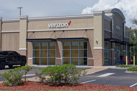 Verizon retail storefront exterior showing glass windows, branded signage. Editorial Use Only September 11,  2026 St. Petersburg, FL USA parking lot and landscaped frontage with shrubs; a customer app