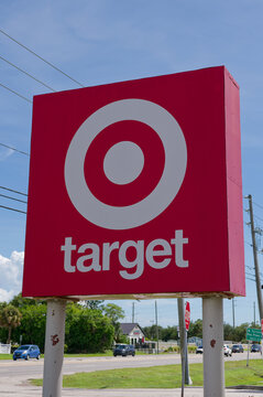 Large red Target logo sign mounted on poles beside a busy road, framed by a clear blue sky. Editorial Use Only September 11,  2026 St. Petersburg, FL USA Passing cars, conveying retail shopping, brand