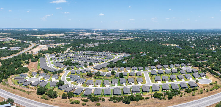 Aerial view of over 55 community in Georgetown Texas with lawns irrigated in summer heat