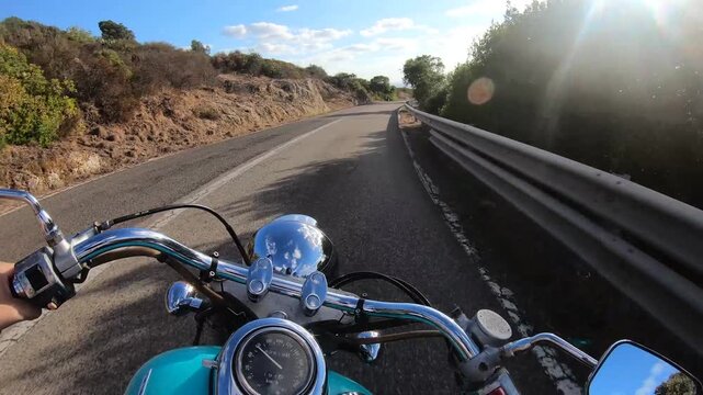 POV ride on a custom turquoise motorcycle descending a winding rural road, with natural engine and exhaust sounds creating an immersive first person motorcycle travel experience.