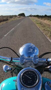 Vertical POV ride on a custom turquoise motorcycle along a rural road, with natural engine and exhaust sounds creating an immersive first person motorcycle travel experience.