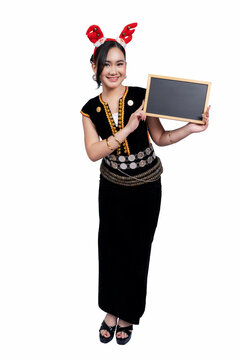 Young women in Kadazan Dusun traditional clothing holding a blackboard white background