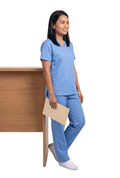 Smiling Nurse in Scrubs Leaning on Wooden Desk