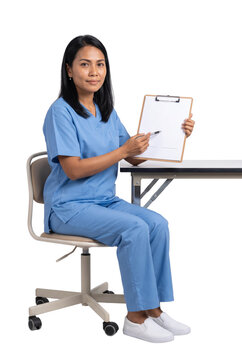Nurse Sitting at Desk Holding Clipboard and Pointing at Form
