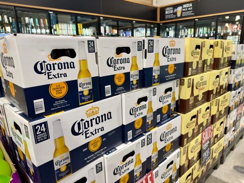 Pile of boxes of Mexican Corona brand beer for sale at a California supermarket aisle