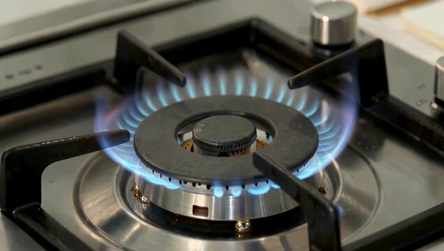 Get an up-close look at the heart of the kitchen with super-close 4K static shot which shows a gas stove burner with vivid blue flames demonstrating precise flame adjustment from full intensity to
