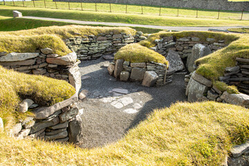 An example of the Bronze Age settlement showing  the small cells radiating off the central hearth area. This building was used by a blacksmith. © Drew