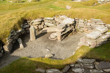 The outline of a Iron Age building showing the small semi-circular cells radiating out from the central space at the Jarlshof settlement on the Shetlands Isles, Scotland © Drew