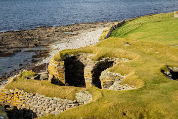 A view of a Wheelhouse built between 2C and 3C CE, the round building has spurs inside to support the roof creating a wheel like effect. This house has been built over the Iron Age Broch © Drew
