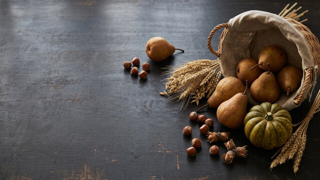 Rustic Harvest Basket with Gourds and Produce on Dark Table