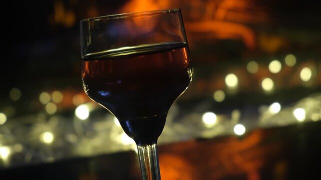 Glass of fine brandy. Rich, warm tones of the spirit mirror the fire&rsquo;s glow, creating a scene steeped in coziness and calm. Perfect winter evening&nbsp;&mdash;&nbsp;slow, indulgent, and utterly peaceful.
