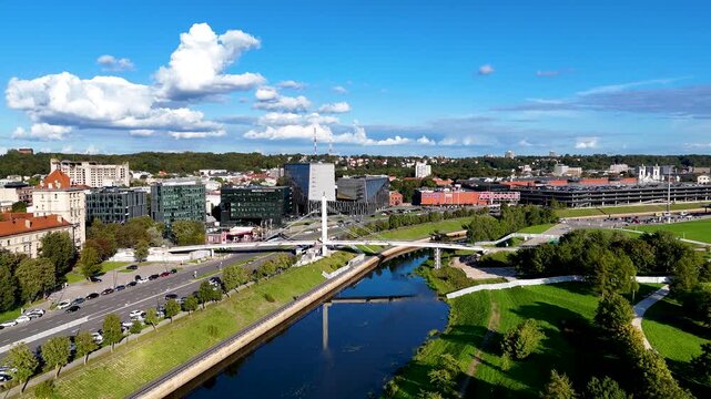Aerial drone view of the modern new city center of Kaunas along the Nemunas River, Lithuania, showcasing contemporary architecture, urban development and waterfront skyline. 4K video footage