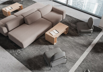 Obraz premium Modern living room interior with modular sofas, lounge chairs, wood tables, and city windows in a realistic style on a neutral rug, 3D Rendering