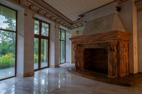 Abandoned luxury mansion interior with marble hall, ornate fireplace, swimming pool and glass facade