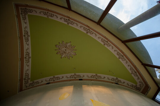 Abandoned luxury mansion interior with marble hall, ornate fireplace, swimming pool and glass facade
