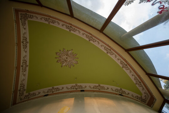 Abandoned luxury mansion interior with marble hall, ornate fireplace, swimming pool and glass facade
