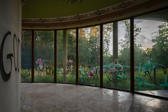Abandoned luxury mansion interior with marble hall, ornate fireplace, swimming pool and glass facade