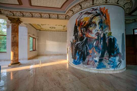Abandoned luxury mansion interior with marble hall, ornate fireplace, swimming pool and glass facade