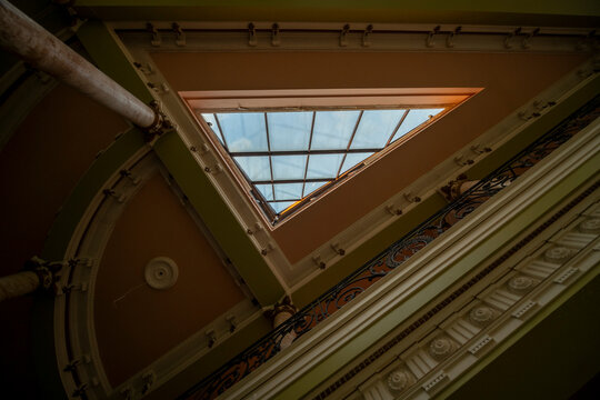 Abandoned luxury mansion interior with marble hall, ornate fireplace, swimming pool and glass facade