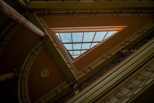Abandoned luxury mansion interior with marble hall, ornate fireplace, swimming pool and glass facade